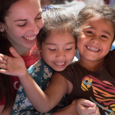 A volunteer and her students clap and sing songs during her teaching work experience in Costa Rica Happy children with their teacher at one of Projects Abroad's volunteer teaching placements in Costa Rica